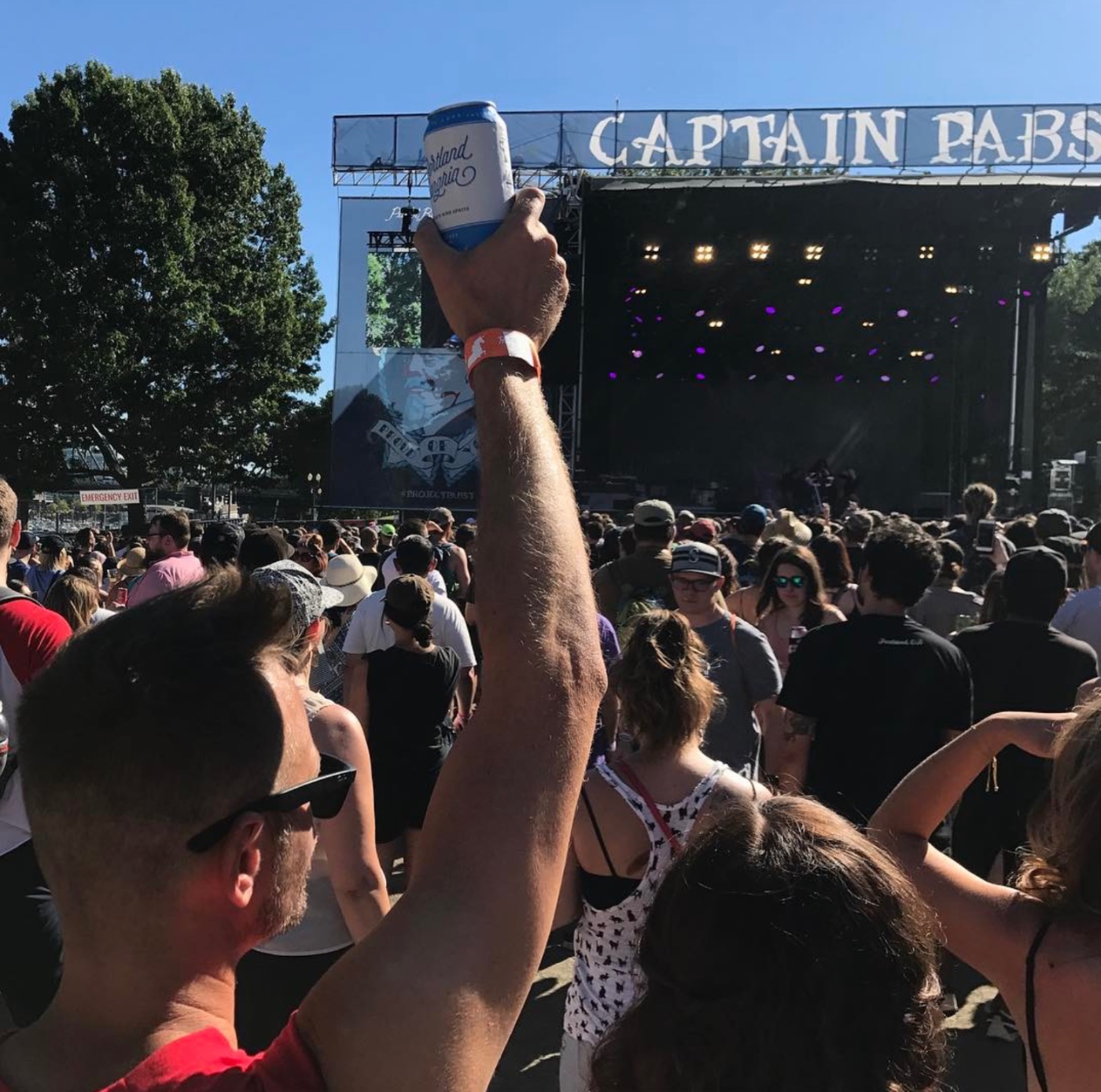 A can raised over the crowd at a Portland music festival