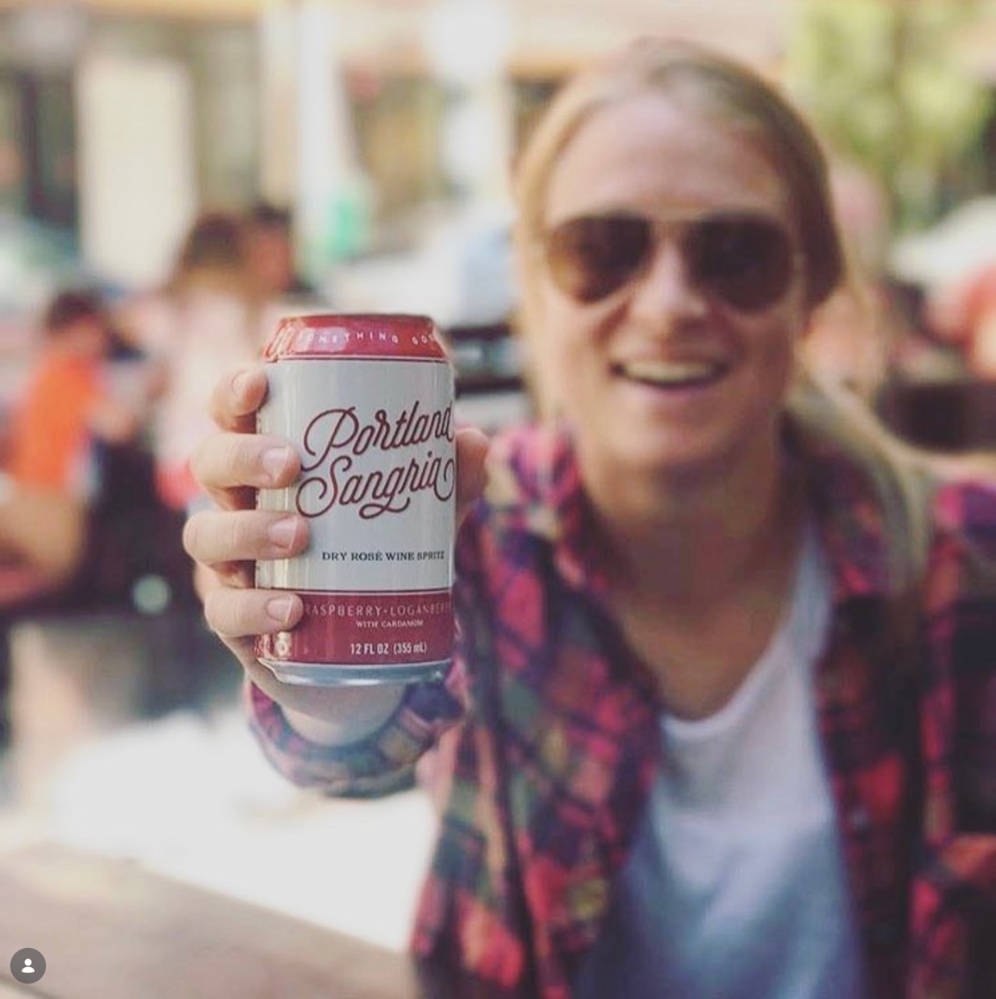 Holding a Raspberry Cardamom can on a sunny patio