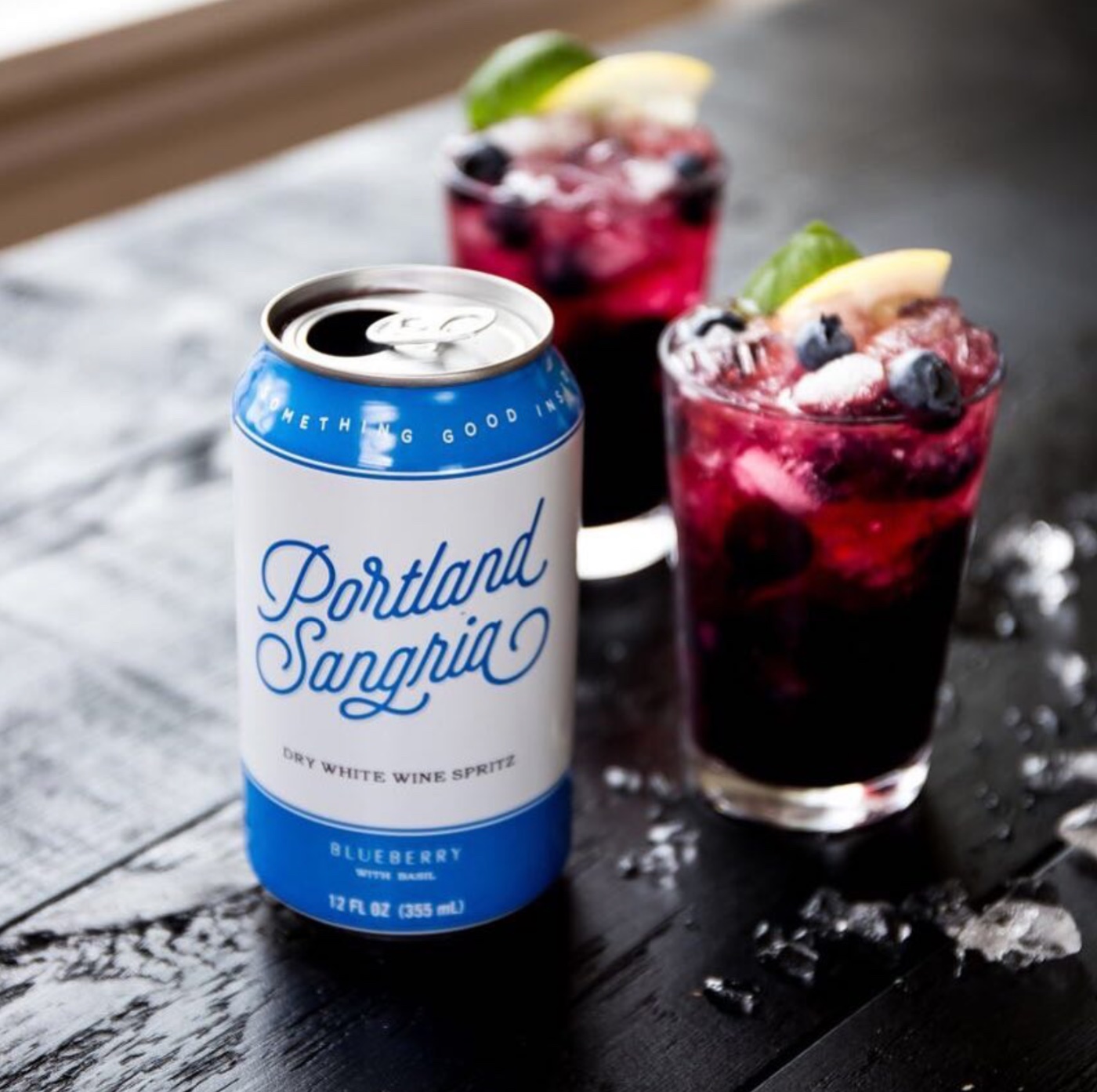 Blueberry Basil sangria over ice with fresh blueberries, basil and lemon